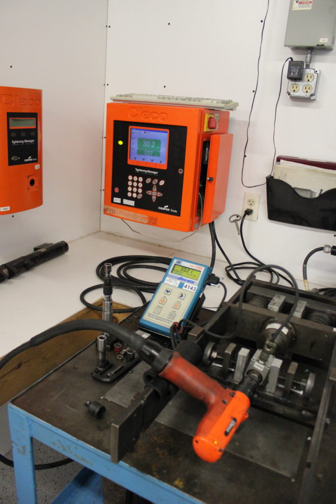 A Cleco electric torque wrench is being tested on a specialty Cleco test stand