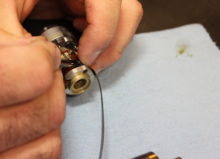 A technician disassembling and inspecting a transducer.