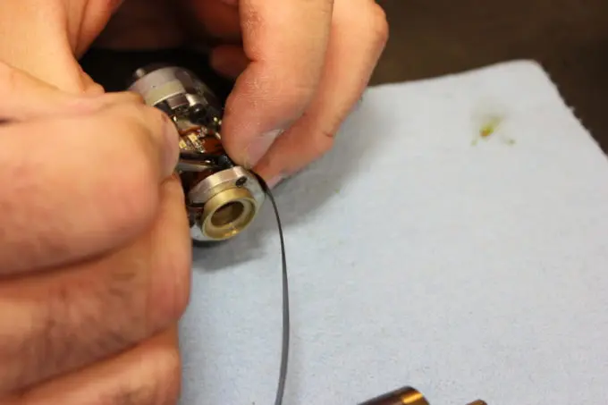 A technician disassembling and inspecting a transducer.