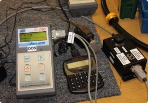 An Atlas Copco controller is being tested and calibrated