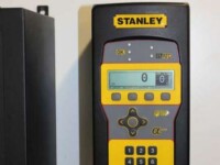 Close-up of a Stanley digital measuring device featuring a display and keypad for precise measurements.